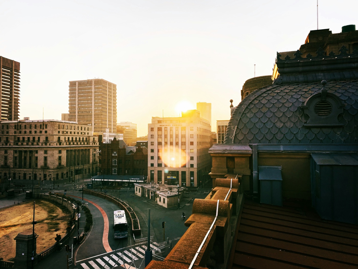 Church Square in Pretoria at golden hour, seen from a rooftop above the historic civic core